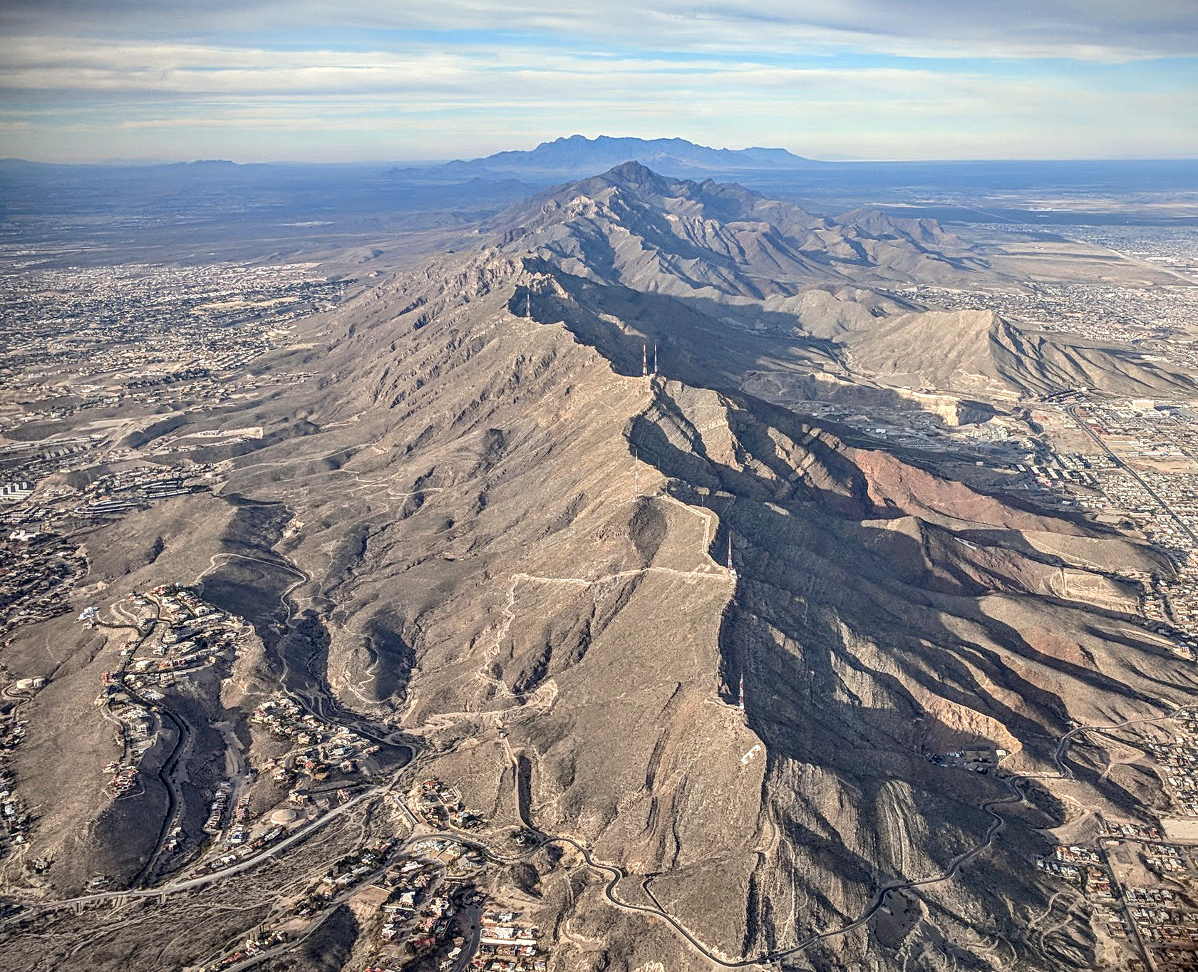 An aerial view along the Franklin Mountains, with El Paso neighborhoods on both sides